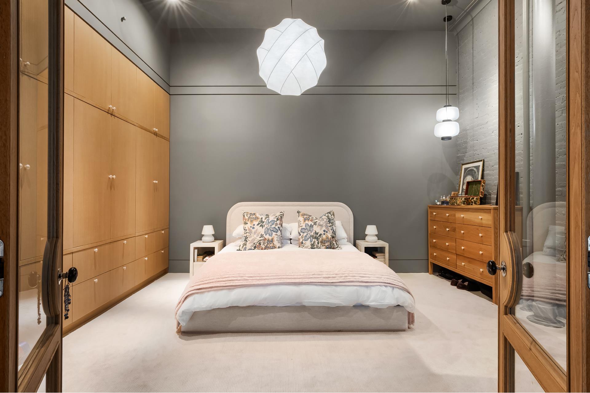 134 Greene Street, Unit 3R Manhattan, NY 10012 - Photo 20 of 25 a bedroom with a bed and a chandelier