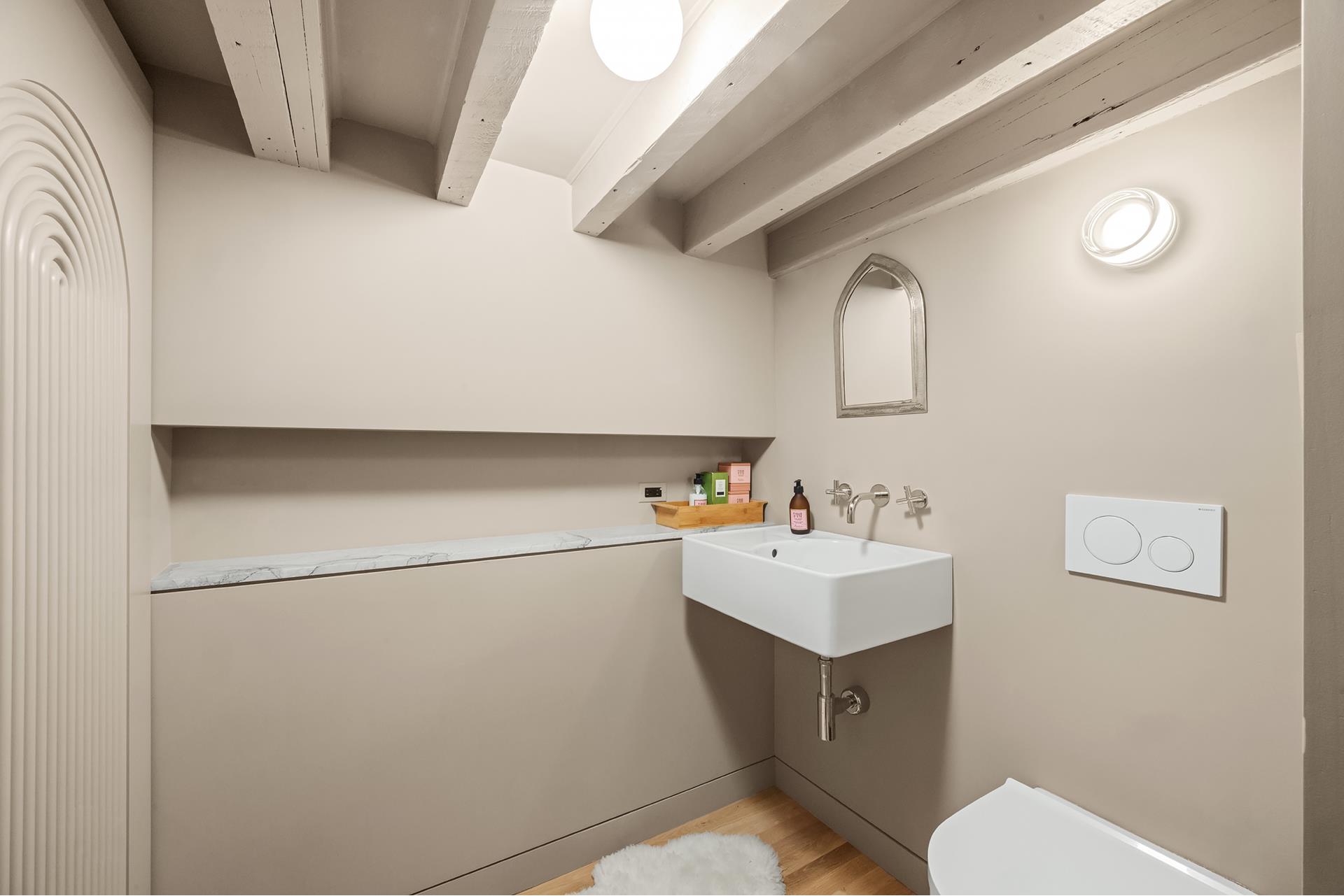 134 Greene Street, Unit 3R Manhattan, NY 10012 - Photo 25 of 25 a bathroom with a sink vanity and toilet