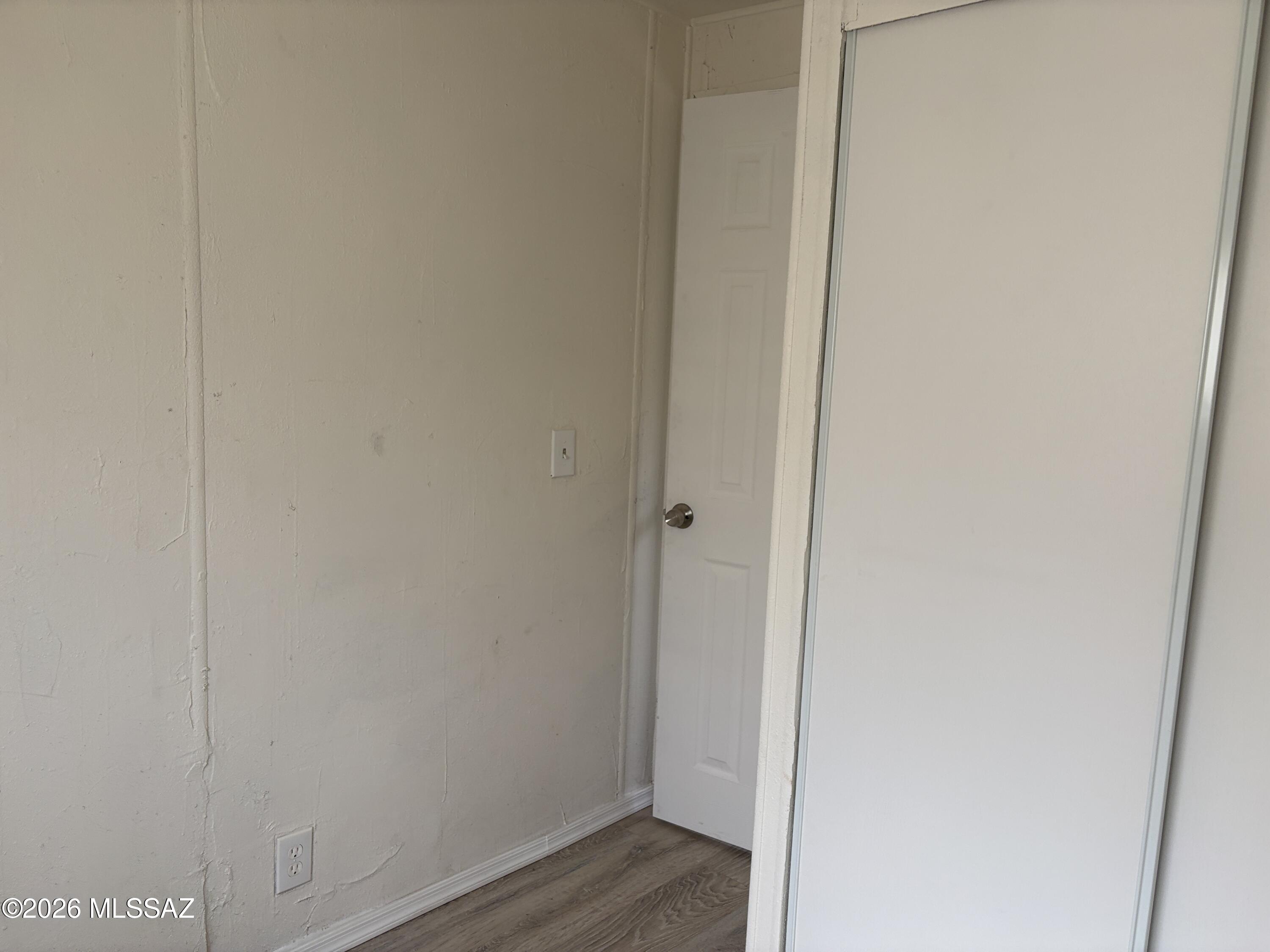 1741 West Wetmore Road, Unit 17 Tucson, AZ 85705 - Photo 7 of 9 a view of a hallway with wooden floor