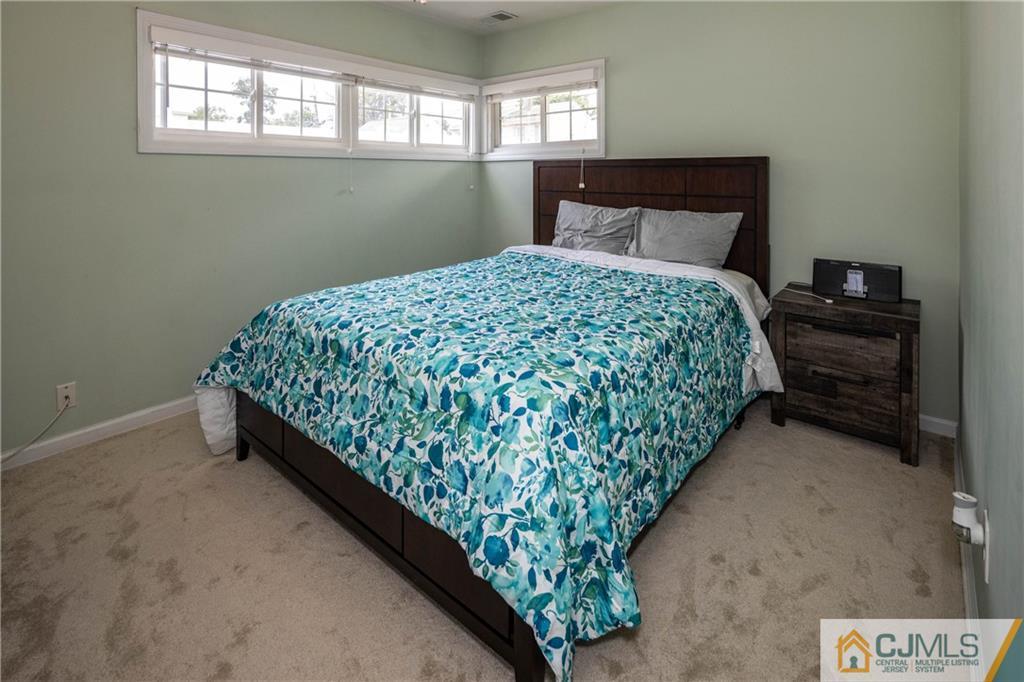 69 Ashley Road Edison, NJ 08817 - Photo 15 of 35 a bed sitting in a bedroom next to a window
