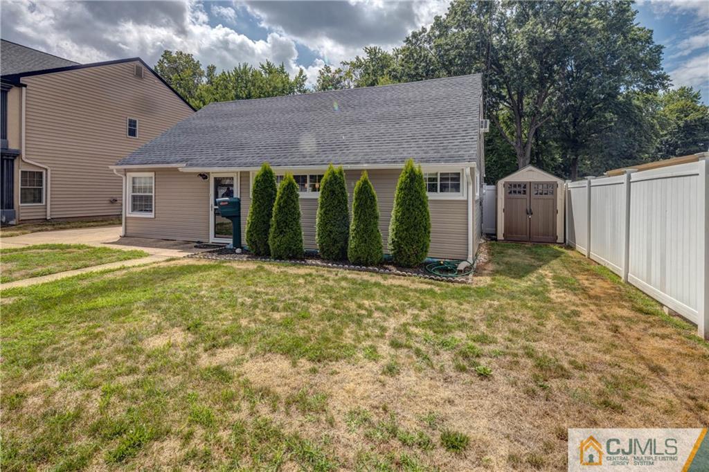 69 Ashley Road Edison, NJ 08817 - Photo 3 of 35 a view of a house with a yard and garage
