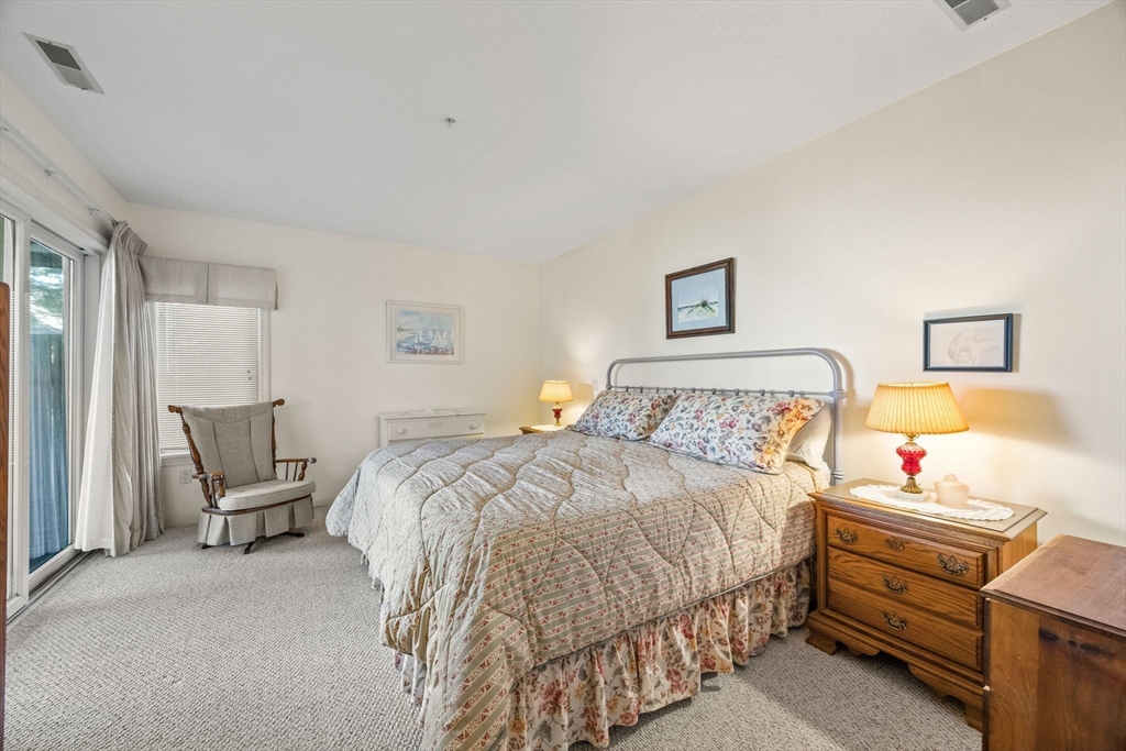 226 Kates Path, Unit 226 Yarmouth, MA 02675 - Photo 13 of 29 a bedroom with a bed and a window