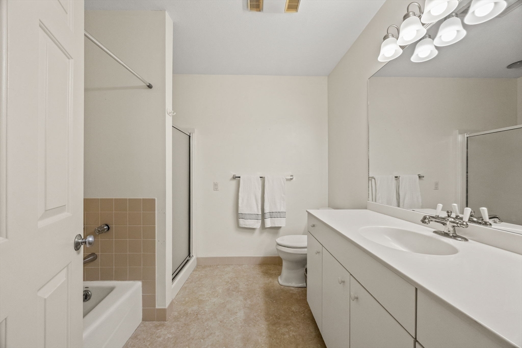 226 Kates Path, Unit 226 Yarmouth, MA 02675 - Photo 14 of 29 a bathroom with a sink a toilet and shower