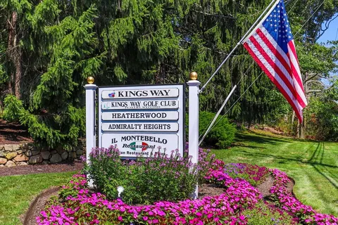 a sign that is in front of flowers
