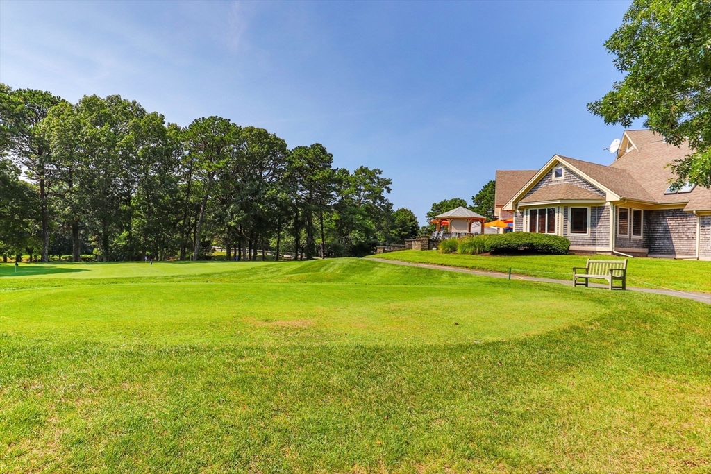 226 Kates Path, Unit 226 Yarmouth, MA 02675 - Photo 24 of 29 a view of a house with a big yard