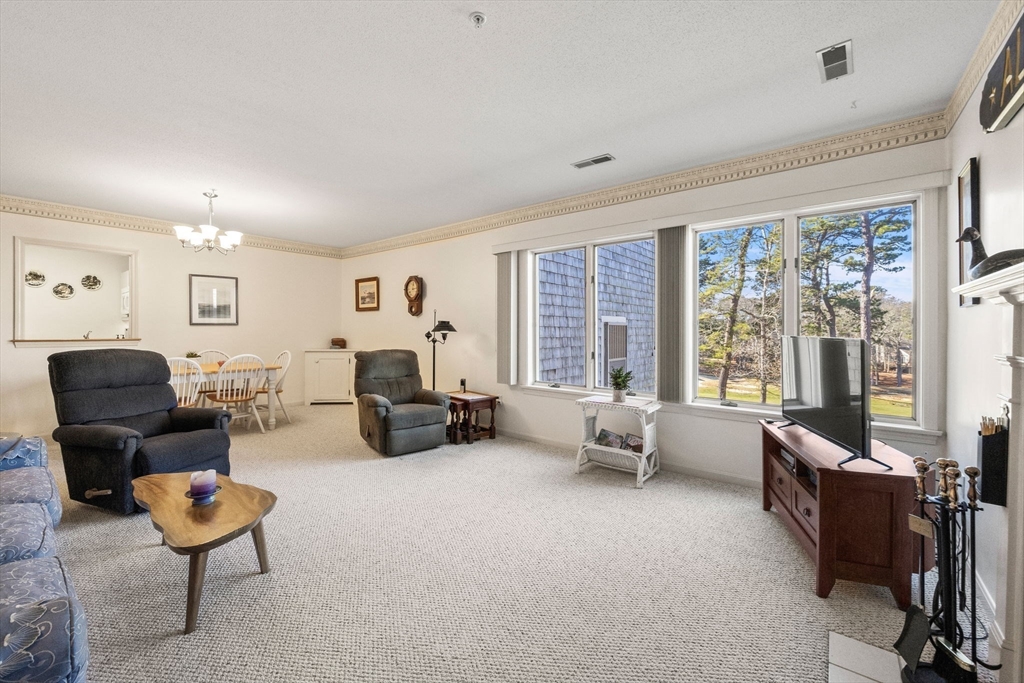 226 Kates Path, Unit 226 Yarmouth, MA 02675 - Photo 8 of 29 a living room with furniture and a large window