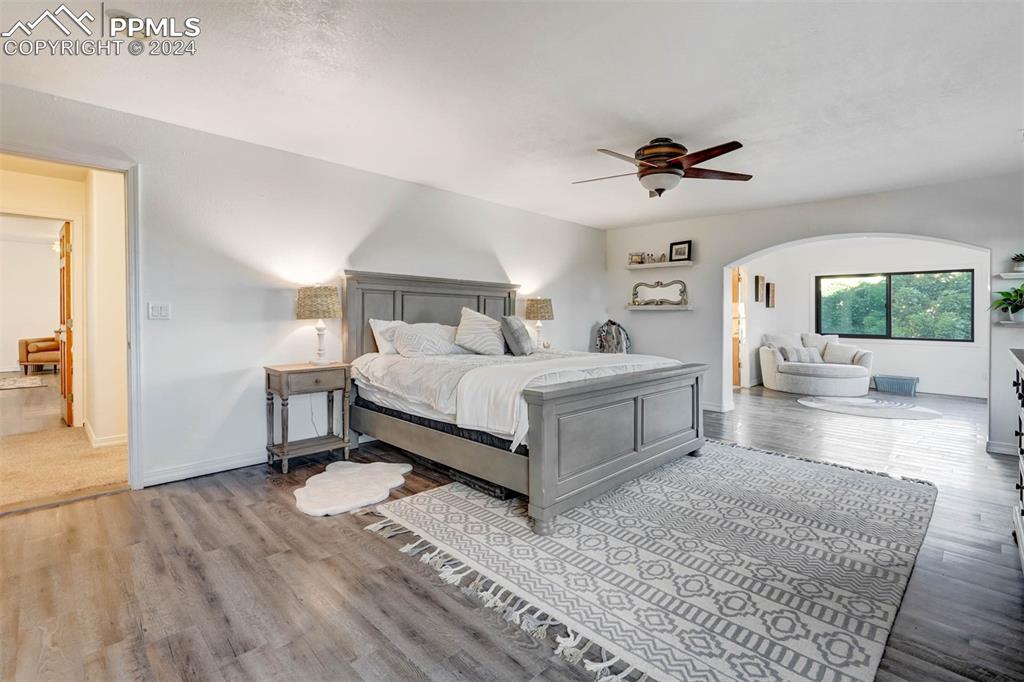 20880 Scott Road Calhan, CO 80808 - Photo 17 of 50 a bedroom with a bed a couches and potted plants with the wooden floor