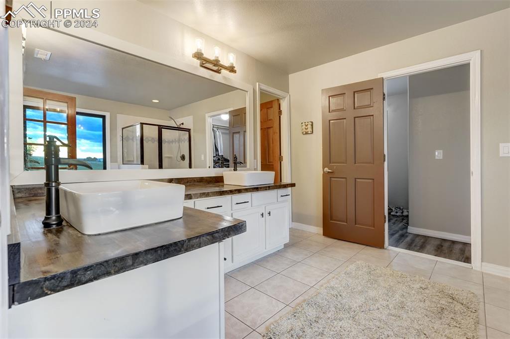 20880 Scott Road Calhan, CO 80808 - Photo 20 of 50 Owners 5 piece bath with tile patterned flooring, vanity, and a standing shower