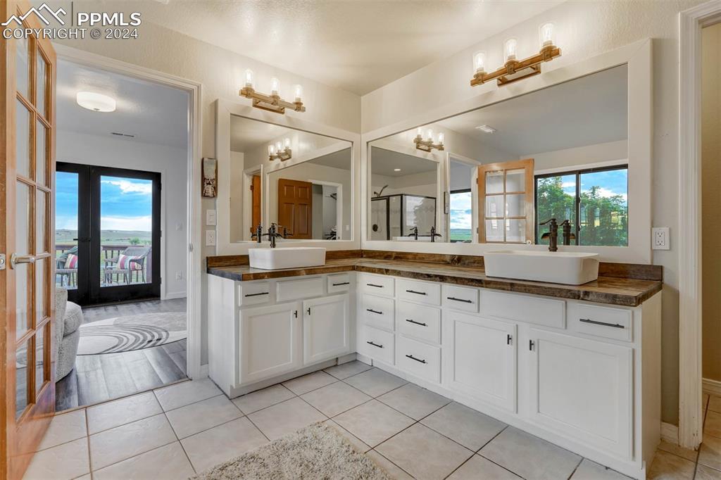 20880 Scott Road Calhan, CO 80808 - Photo 22 of 50 Bathroom featuring tile patterned floors, french doors, vanity, and a chandelier