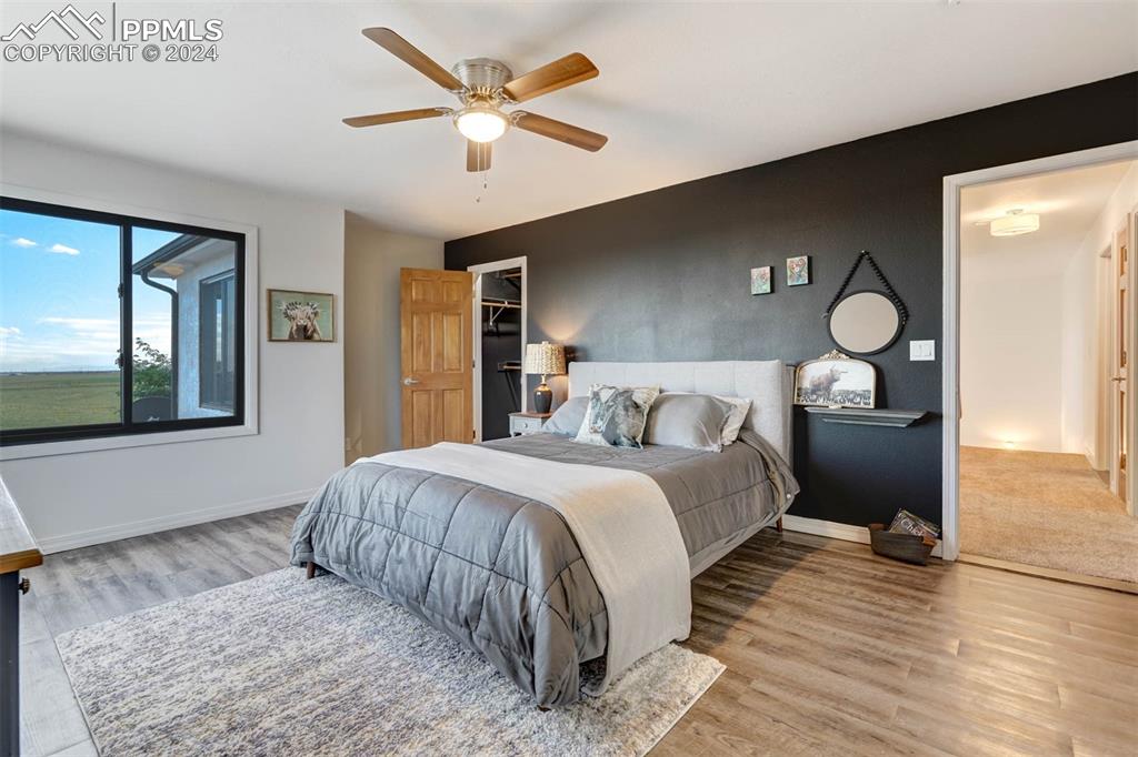 20880 Scott Road Calhan, CO 80808 - Photo 29 of 50 a bedroom with a large bed and a chandelier