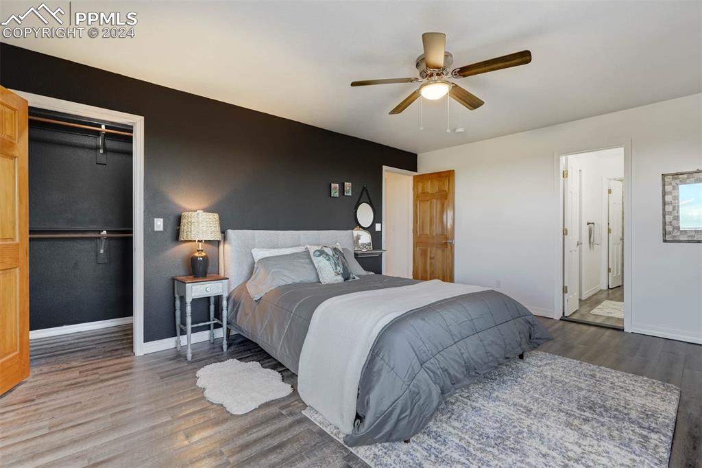 20880 Scott Road Calhan, CO 80808 - Photo 31 of 50 a bedroom with a bed and a ceiling fan