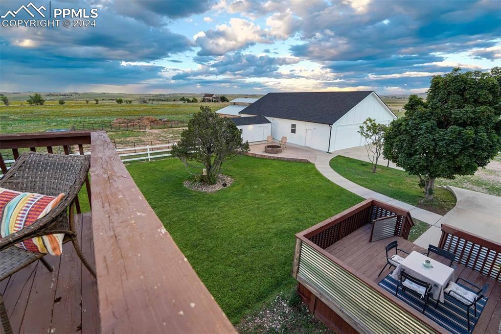 20880 Scott Road Calhan, CO 80808 - Photo 32 of 50 a view of a patio with lawn chairs floor to ceiling window and an outdoor seating