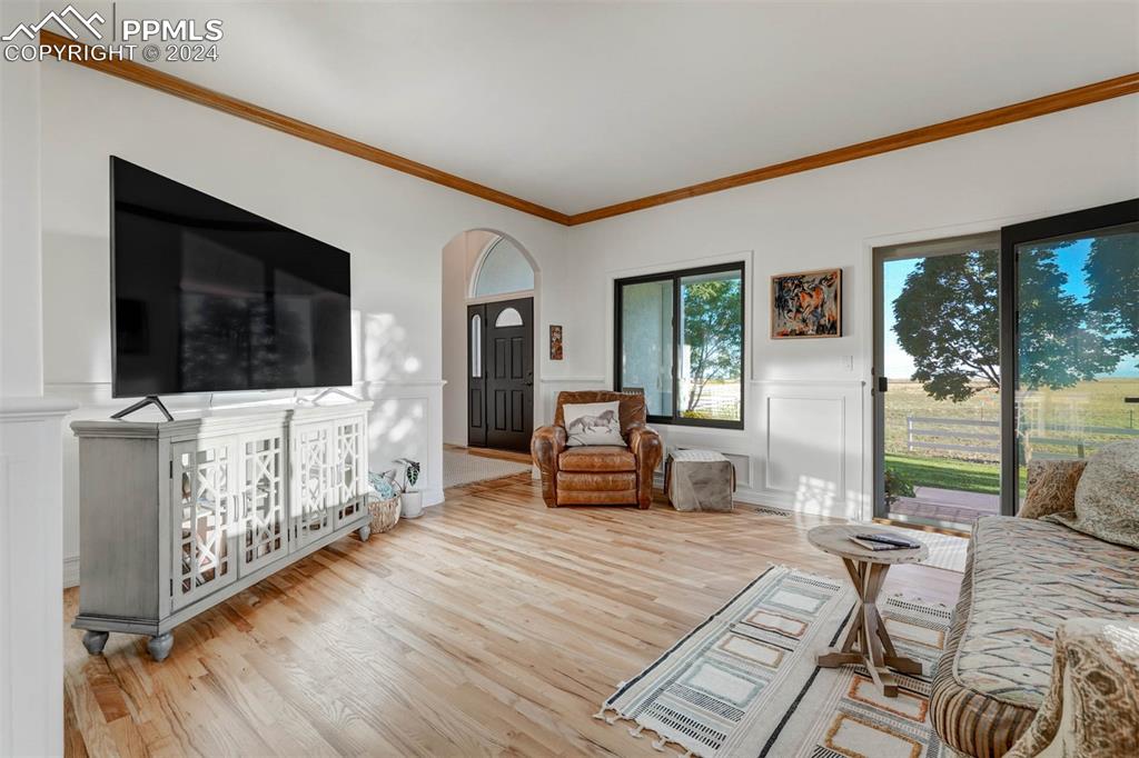 20880 Scott Road Calhan, CO 80808 - Photo 4 of 50 Living room with light hardwood / wood-style flooring and ornamental molding