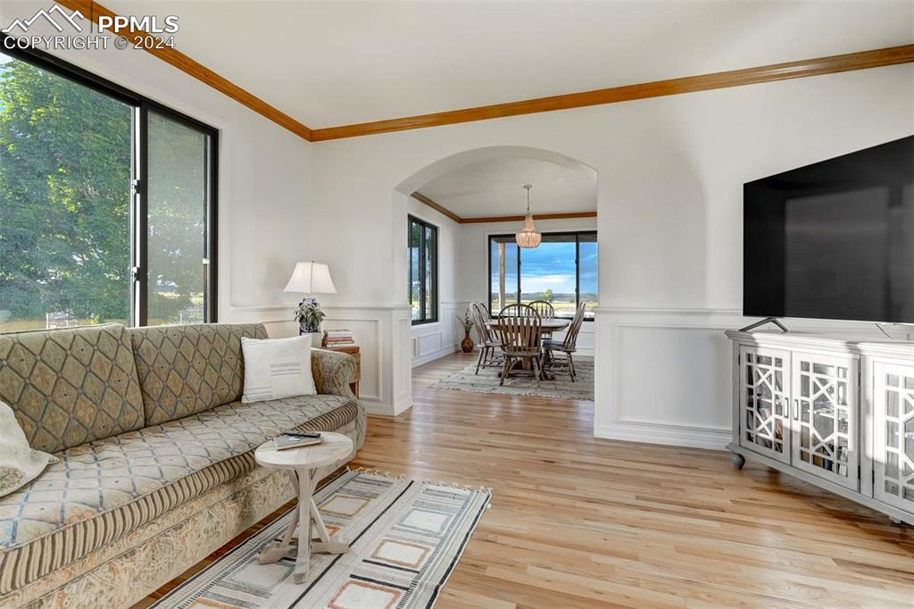 20880 Scott Road Calhan, CO 80808 - Photo 5 of 50 Living room with light hardwood / wood-style floors and ornamental molding