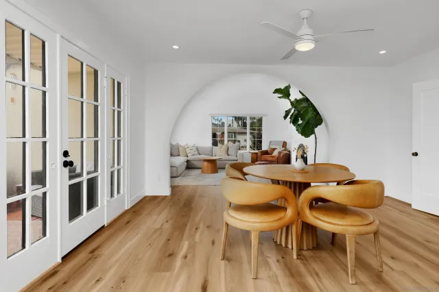 a dining room with furniture a window and wooden floor