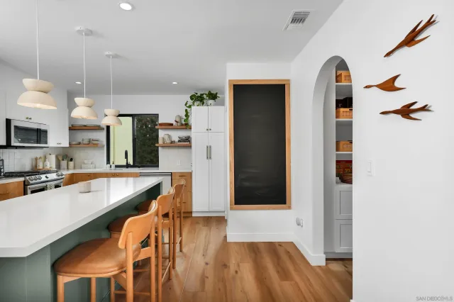 a kitchen with stainless steel appliances granite countertop a refrigerator a sink and a stove