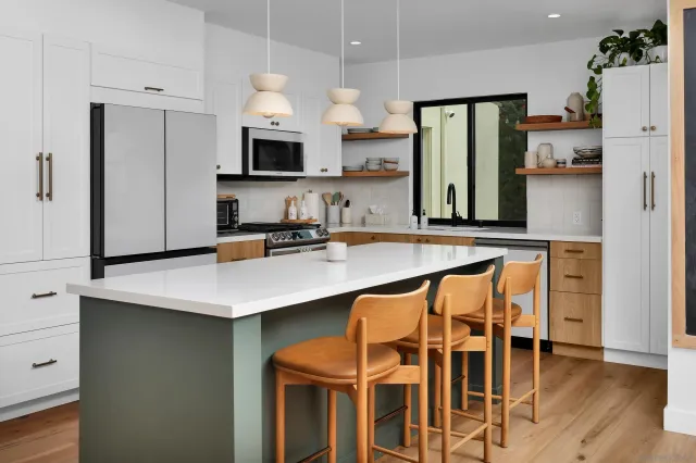 a kitchen with stainless steel appliances a sink and a refrigerator