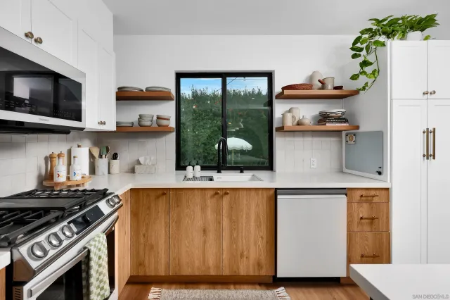 a kitchen with a stove a sink and a microwave