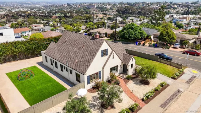 an aerial view of a house with a garden and lake view