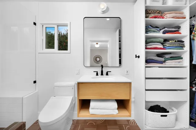 a bathroom with a sink a toilet and shower curtain