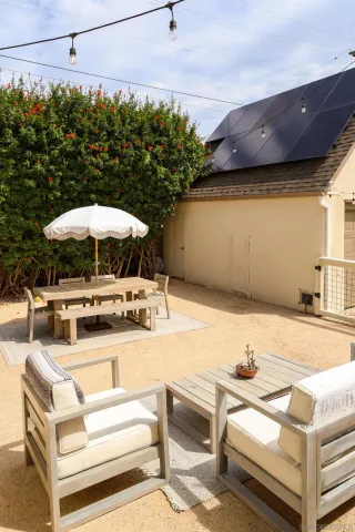 a view of a patio with chairs and umbrellas