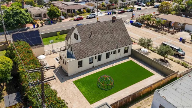 an aerial view of a tennis ground with a swimming pool