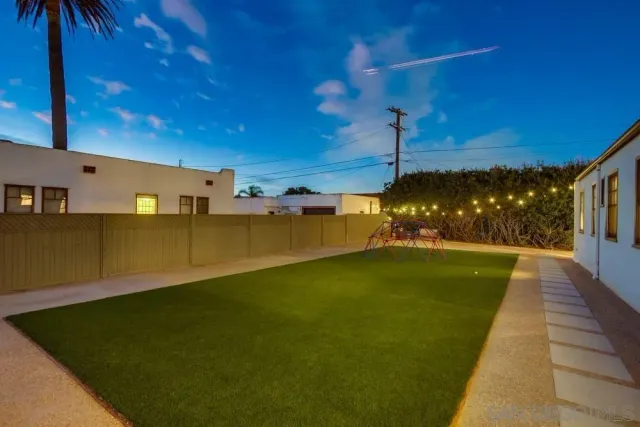 a swimming pool with outdoor seating and yard