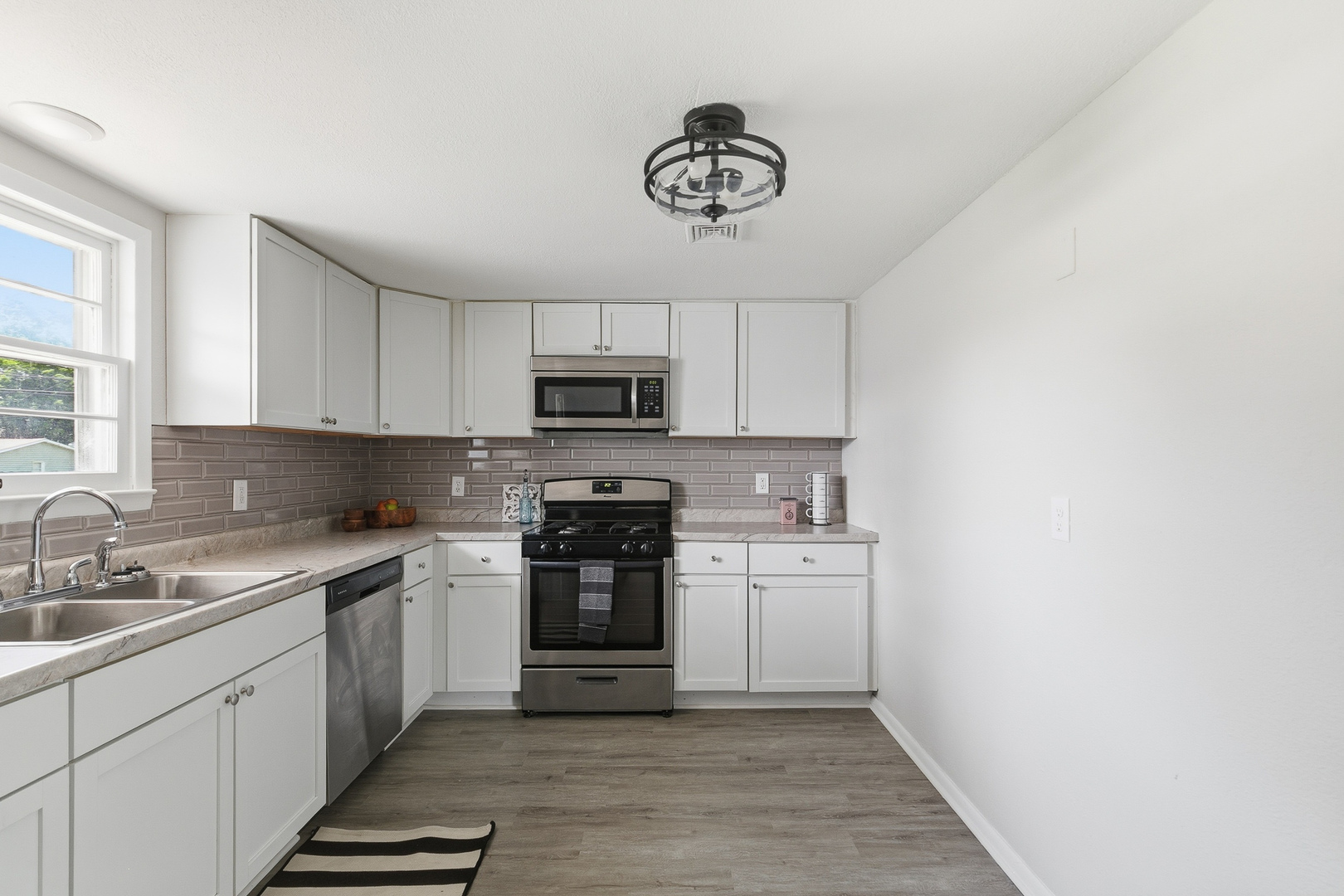 2306 9th Street Silvis, IL 61282 - Photo 13 of 32 a kitchen with a sink cabinets and stainless steel appliances