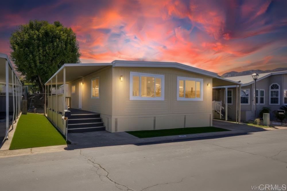 a front view of a house with a garden