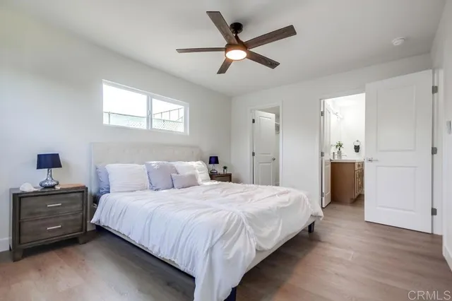 a bedroom with a bed and a ceiling fan
