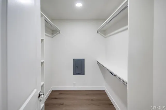 a view of hallway with stairs and wooden floor