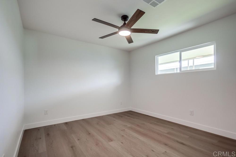 8301 Mission Gorge Road, Unit 208 Santee, CA 92071 - Photo 19 of 22 an empty room with wooden floor and windows