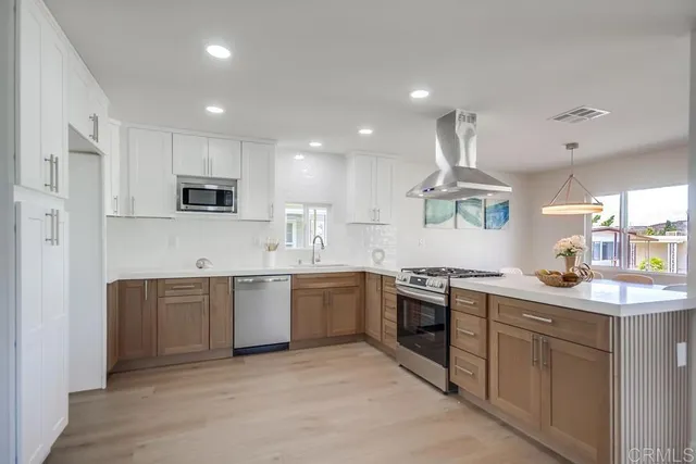 a kitchen with stainless steel appliances granite countertop a sink and stove top oven