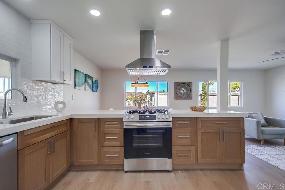 8301 Mission Gorge Road, Unit 208 Santee, CA 92071 - Photo 10 of 22 a kitchen with kitchen island granite countertop a sink and cabinets