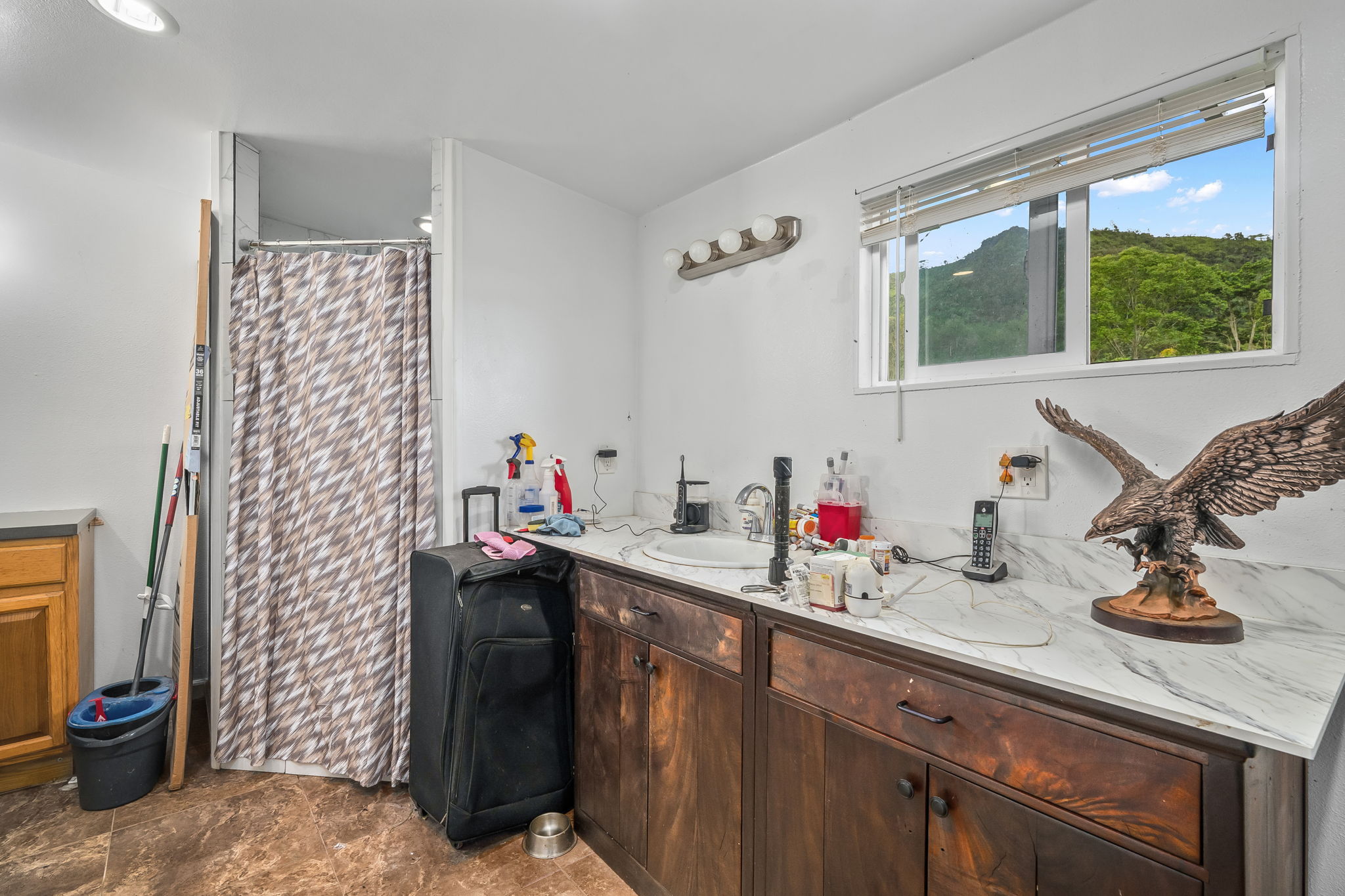 7060 Kahuna Road Kapaa, HI 96746 - Photo 12 of 25 a kitchen with a sink cabinets and a window