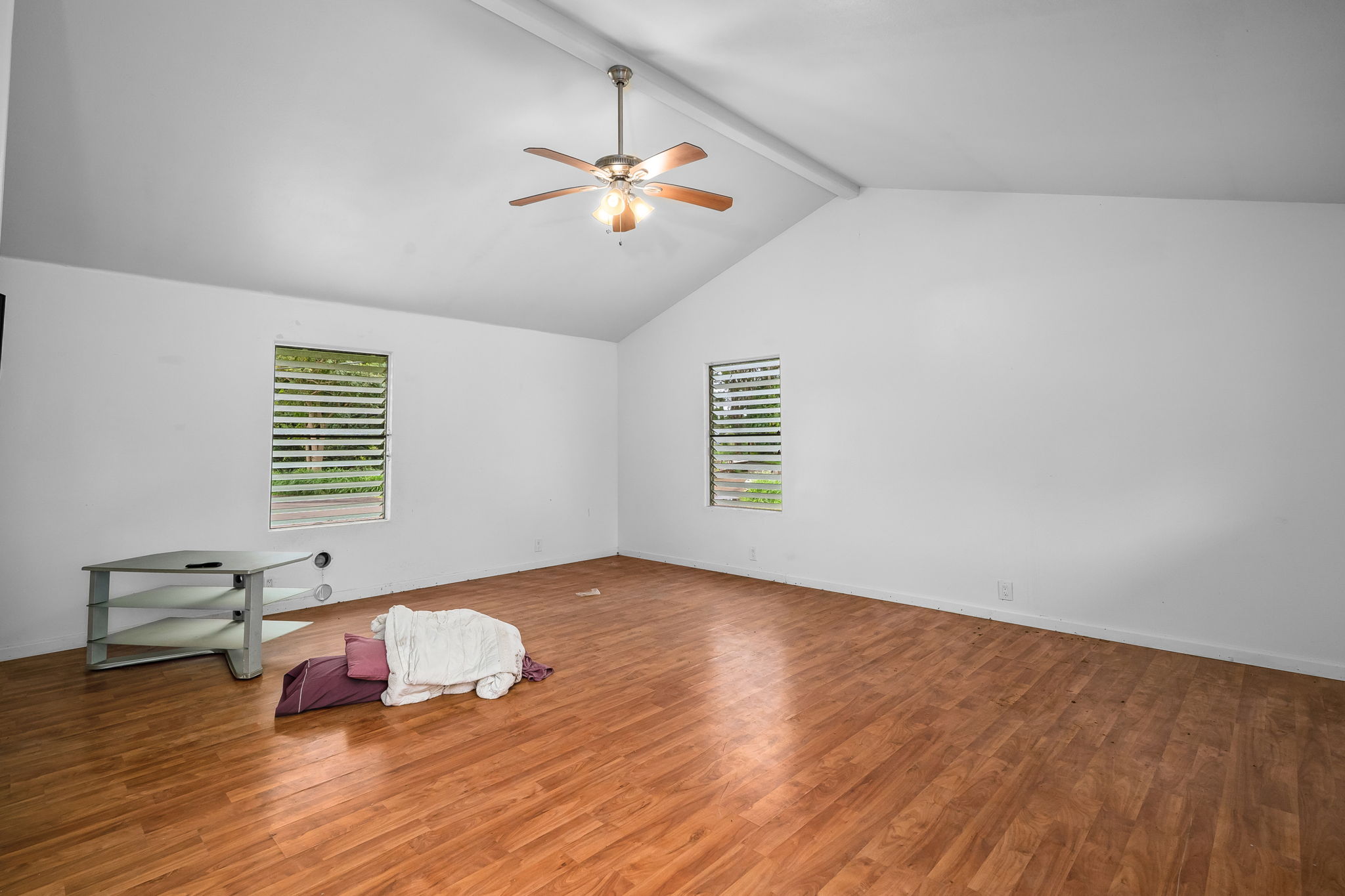 7060 Kahuna Road Kapaa, HI 96746 - Photo 16 of 25 a view of a room with wooden floor and ceiling fan