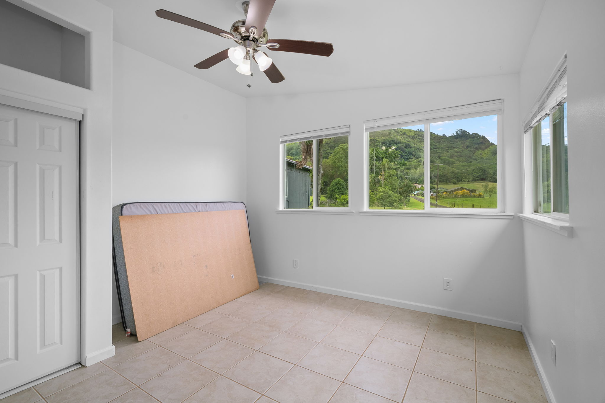 7060 Kahuna Road Kapaa, HI 96746 - Photo 17 of 25 an empty room with windows and fan