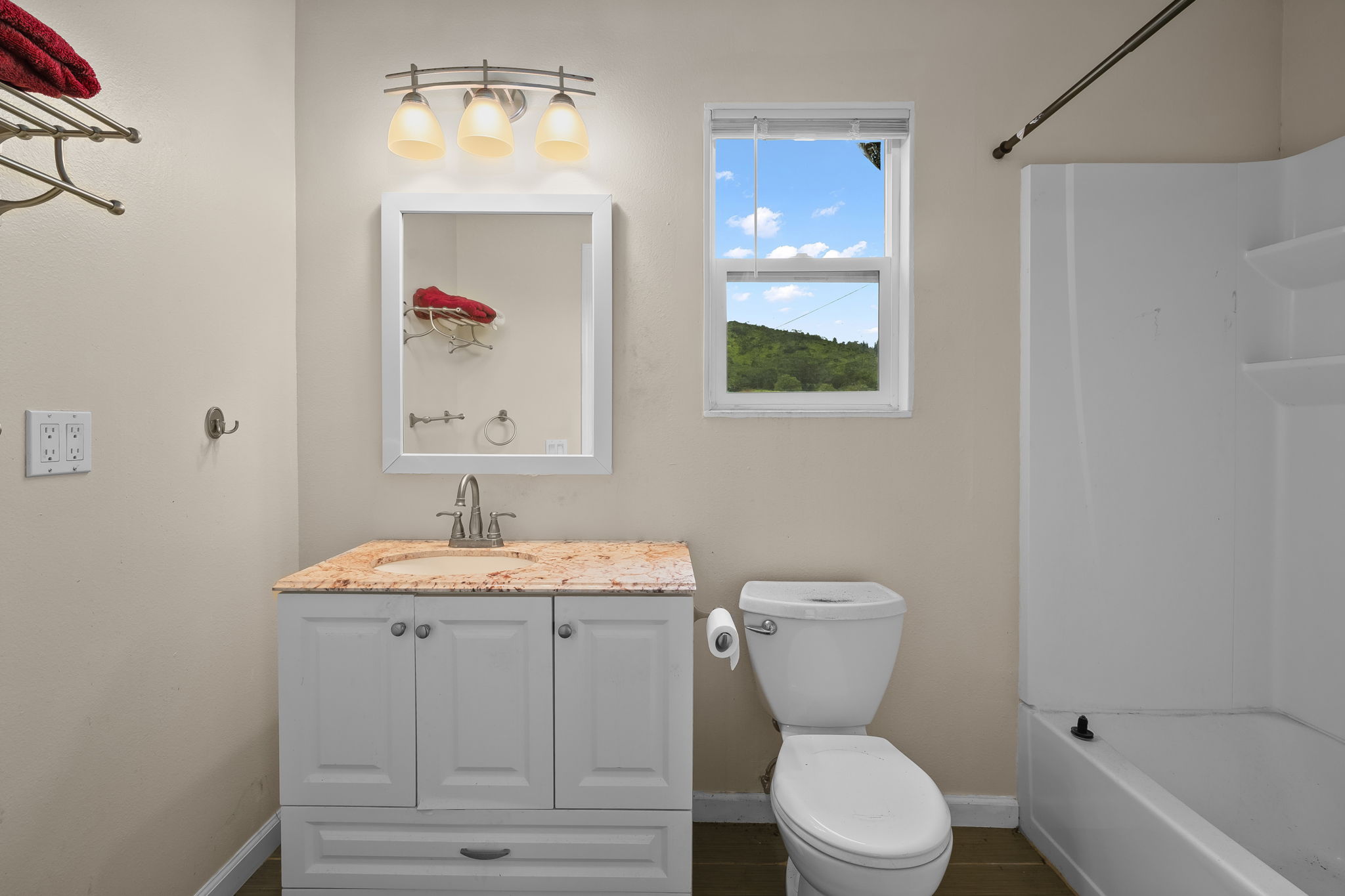 7060 Kahuna Road Kapaa, HI 96746 - Photo 19 of 25 a bathroom with a toilet a sink and mirror