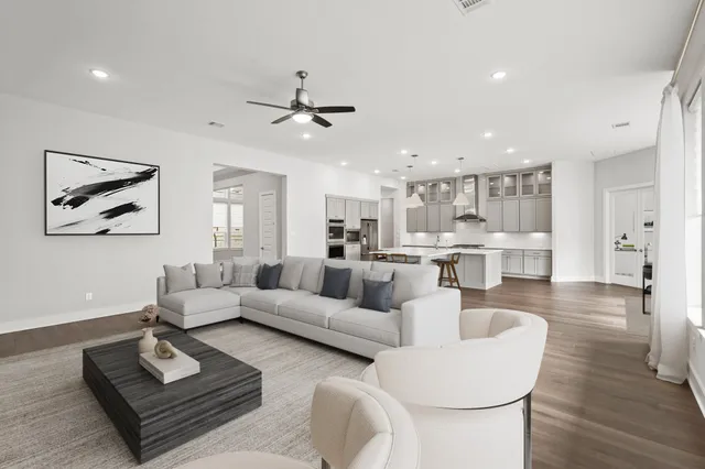 a living room with furniture and a view of kitchen