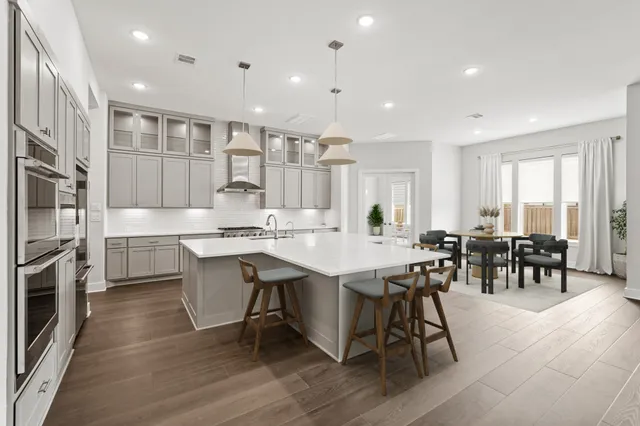 a large kitchen with a table and chairs