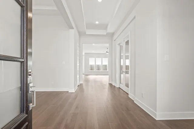 a view of a hallway with wooden floor