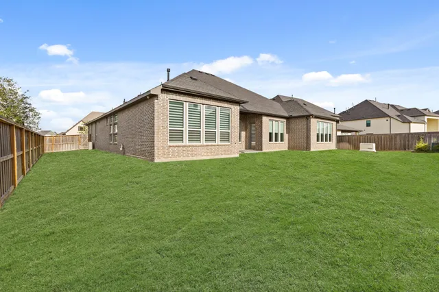 an aerial view of a house with a yard basket ball court and outdoor seating