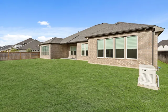 a view of a patio with chairs and plants