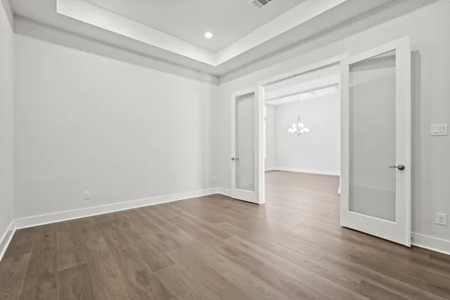 a view of an empty room with wooden floor
