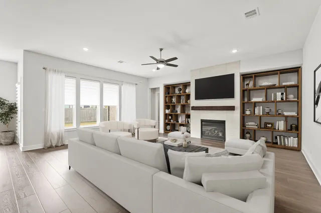 a living room with furniture a fireplace and a flat screen tv
