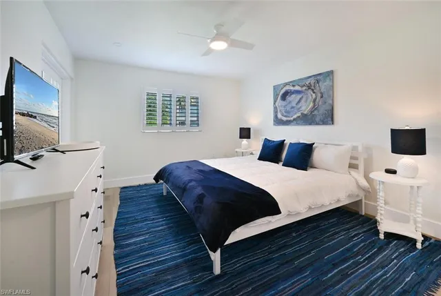 a bedroom with bed and wooden floor