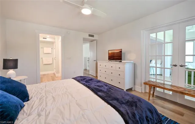 a bedroom with a bed and a television