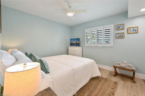 a bedroom with a bed and chair