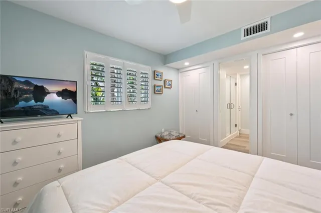 a bedroom with a bed and a dresser