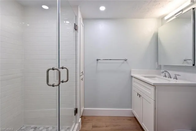 a bathroom with a sink a mirror and shower